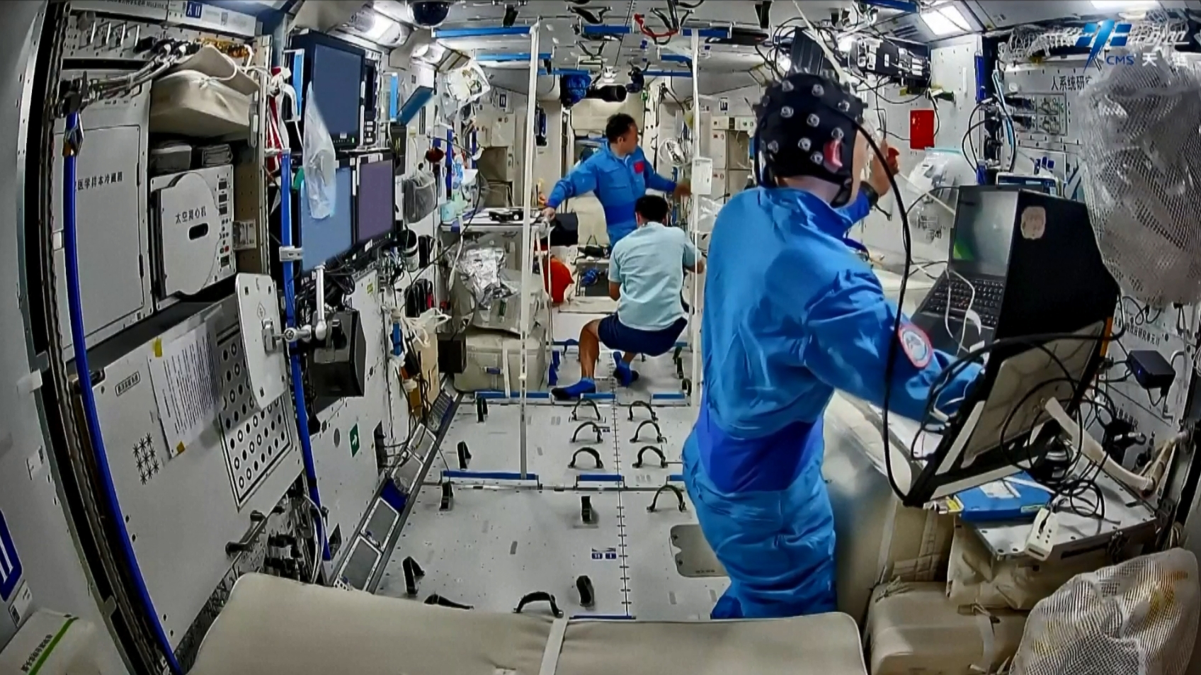 The Shenzhou-21 crew conduct experiments aboard China's space station. /via CMG