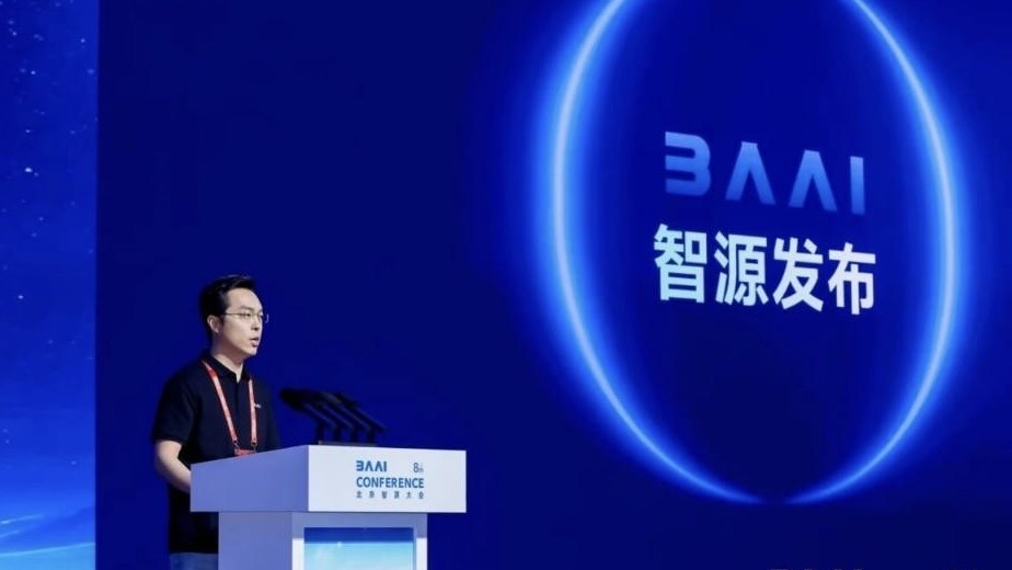 A speaker presents new AI research during the 8th Beijing Academy of AI Conference in Beijing, China, June 2026. /BAAI